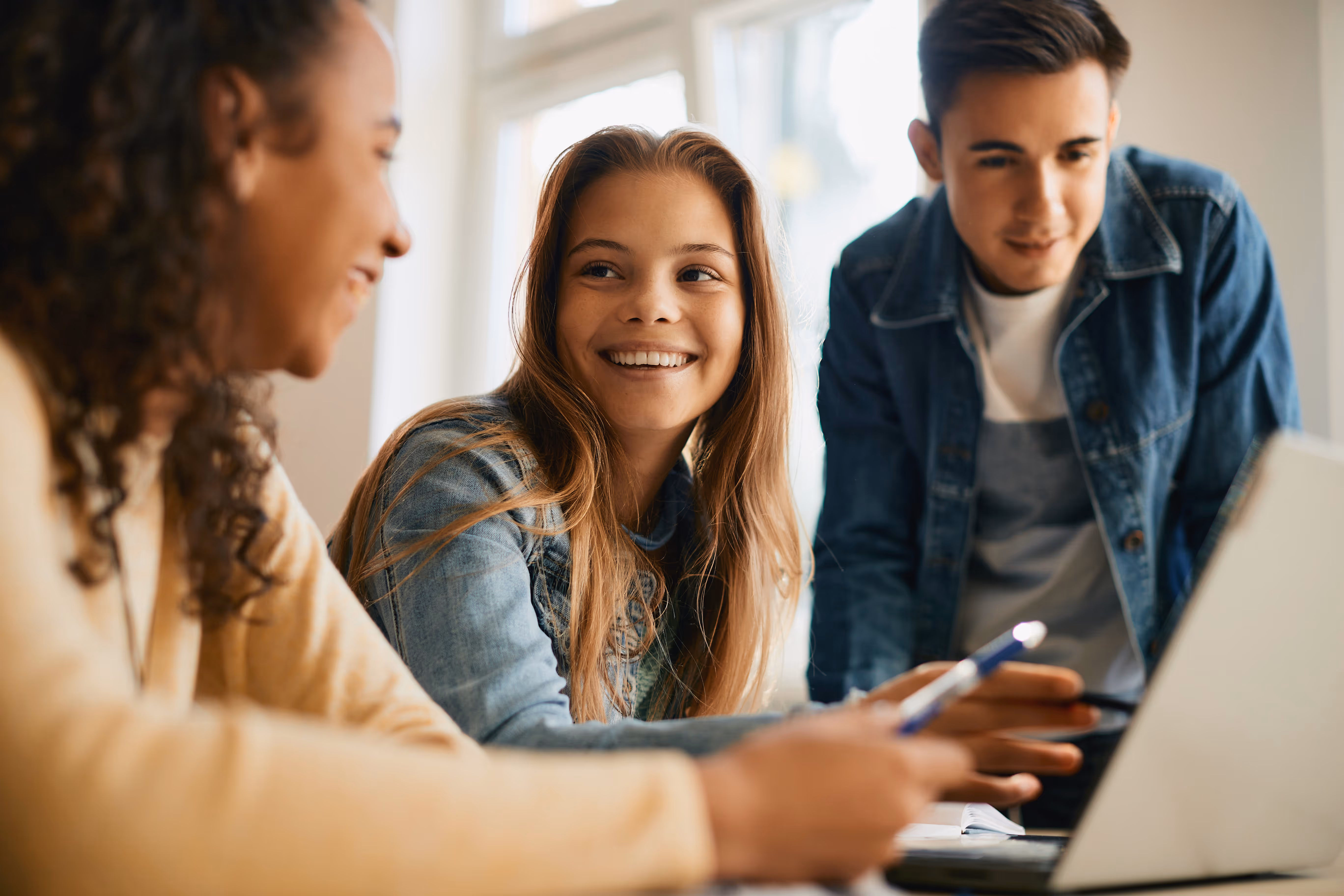Teens working together on laptops